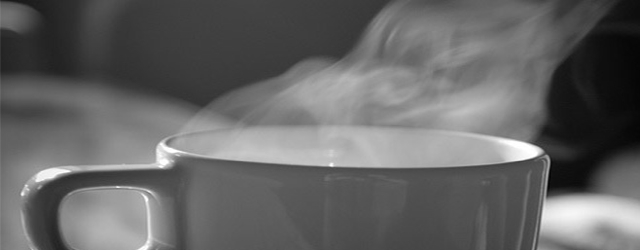 Masthead photograph of a steaming cup of coffee 